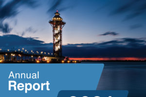 Cover of the MHEDS Annual Report 2021, Pandemic Edition, featuring a waterfront tower at sunset with lights reflected on the water.