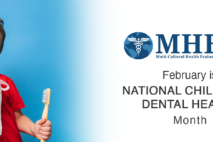 Smiling young boy holds a plush tooth and a large toothbrush, standing next to text that reads “February is National Children’s Dental Health Month” with the MHEDS logo above.