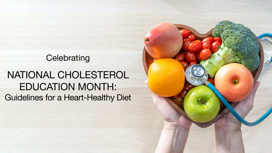 Hands holding a heart-shaped bowl filled with fruits and vegetables, such as apples, oranges, tomatoes, and broccoli, with a stethoscope draped over the bowl; text promotes National Cholesterol Education Month and heart-healthy diet guidelines.