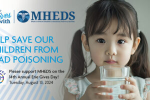 A young girl holds a glass of water. Text beside her reads, Help save our children from lead poisoning. Please support MHEDS on the 14th Annual Erie Gives Day! Tuesday, August 13, 2024. Erie Thrives and MHEDS logos appear above.