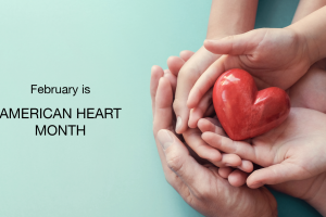Hands of an adult and child holding a red heart together on a blue background. Text on the left reads: February is AMERICAN HEART MONTH.