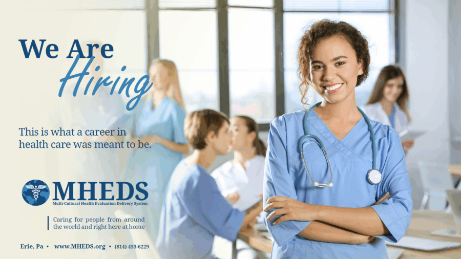 A smiling female nurse stands with arms crossed in a bright hospital room; other healthcare professionals are talking in the background. Text reads We are hiring with contact info for MHEDS, a healthcare organization.