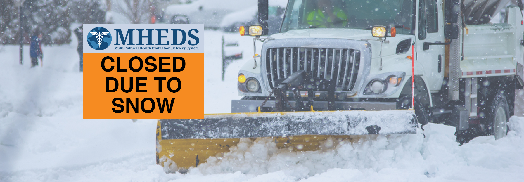 A snowplow clears a road during heavy snowfall. A sign on the image reads, “MHEDS CLOSED DUE TO SNOW.”.