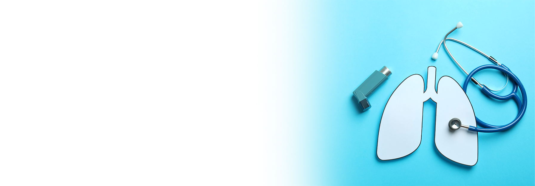 Paper cutout of lungs with a stethoscope placed on top, an inhaler, and an otoscope on a blue background with white space on the left.